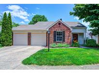 Charming brick home featuring a two-car garage and well-maintained front yard at 6740 Sundown S Dr, Indianapolis, IN 46254