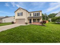 Charming two-story home with a well-manicured lawn and attached two-car garage at 770 Tulip Ln, Greenwood, IN 46143