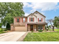Attractive two-story home with a brick and siding facade, red shutters, a covered porch, and a well-kept lawn at 7755 Dayflower Ct, Noblesville, IN 46062