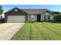 Charming single-story home featuring a well-manicured lawn and attached two-car garage at 1202 Tomahawk Pl, Martinsville, IN 46151