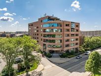Stunning exterior view of building with blue tinted windows on a sunny day at 225 N New Jersey St # 52, Indianapolis, IN 46204