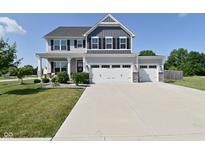Charming two-story home with a three-car garage and well-maintained landscaping at 2734 Chalbury Dr, Plainfield, IN 46168