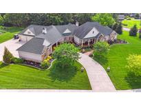 Expansive home with lush landscaping, long driveway, and three-car garage at 3399 Nottinghill Blvd, Plainfield, IN 46168