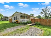 Charming single story home featuring a front porch with hanging plants and a gravel driveway at 405 N Church St, Mooresville, IN 46158