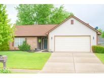 Charming single-story home with a well-manicured lawn and a two-car garage at 444 Austin Dr, Avon, IN 46123