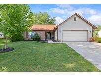 Charming ranch home featuring a manicured lawn, brick accents, and an attached two-car garage at 444 Austin Dr, Avon, IN 46123