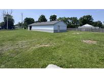 Exterior shot of home with nice yard, trees, and blue skies at 4503 W Minnesota St, Indianapolis, IN 46241
