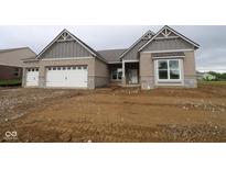 Charming single Gathering home features brick exterior, white garage doors, and architectural roofline details at 4999 Hummingbird Dr, Brownsburg, IN 46112