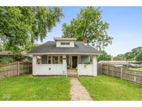 Charming bungalow-style home with a well-manicured lawn and inviting brick pathway at 702 S Keystone Ave, Indianapolis, IN 46203