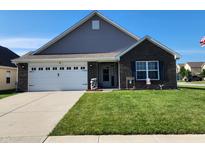 Charming single-Gathering home with a well-manicured lawn, brick facade, and a two-car garage in a suburban neighborhood at 7511 Eddie Ln, Camby, IN 46113