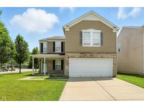 Charming two-story home with a well-maintained lawn and a two-car garage at 8301 Wheatfield Dr, Camby, IN 46113