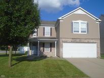Charming two-story home with a two car garage, a well kept yard, and a covered entryway at 8301 Wheatfield Dr, Camby, IN 46113