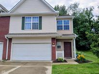 Two story home featuring vinyl siding, attached two-car garage and landscaped front yard at 8333 Pine Branch Ln, Indianapolis, IN 46234