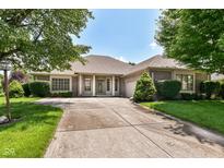 Charming brick home with a well-manicured lawn and a spacious driveway for curb appeal at 10005 Southwind Dr, Indianapolis, IN 46256