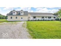 Charming exterior view of the home showcasing the well-maintained lawn and inviting architecture at 10705 N State Road 267, Brownsburg, IN 46112