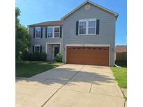 Charming two-story home featuring a two-car garage, tidy landscaping, and classic curb appeal at 10775 Cyrus Dr, Indianapolis, IN 46231