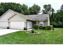 Charming home featuring a well-manicured lawn, attached garage, and lovely landscaping at 1223 Long Shore Dr, Indianapolis, IN 46217