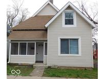 Charming home featuring a screened-in porch, neutral siding, and a cozy facade at 1553 W New York St, Indianapolis, IN 46222