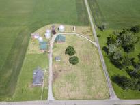 Aerial view of farm with agricultural land, multiple buildings, and grain silos at 17550 N 200 W, Summitville, IN 46070