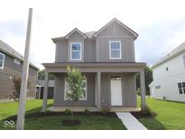 Charming two-story home with a covered front porch and well-manicured lawn showcasing curb appeal at 1817 Real St, Indianapolis, IN 46240