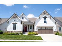 Charming two-story home featuring stone accents, white siding, a red door, and a two-car garage at 1872 Wellpark Dr, Westfield, IN 46074