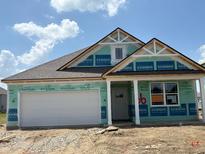 Charming single-story home with a two-car garage under construction with blue sky and clouds at 188 Springfield Xing, Greenfield, IN 46140
