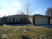 Charming single-story brick home featuring an attached two-car garage and a well-maintained front lawn at 3441 Crickwood Dr, Indianapolis, IN 46268
