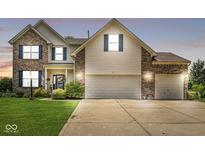 Two-story home featuring brick accents, neutral siding, and a three-car attached garage at 360 Myers Lake Dr, Noblesville, IN 46062