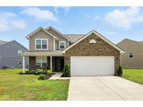 Charming two-story home with a brick and vinyl exterior, well-manicured lawn, and attached two-car garage at 4643 Darla Ct, Indianapolis, IN 46239