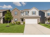 Charming two-story home with a brick and siding exterior, well-maintained lawn, and an attached two-car garage at 5809 Terracotta Trce, McCordsville, IN 46055