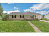 Charming single-story home with a welcoming front porch and well-maintained lawn at 609 Willow Dr, Shelbyville, IN 46176