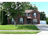 Charming brick two-story home with green shutters and manicured lawn, offering classic curb appeal at 6161 E Runnymede Ct, Camby, IN 46113