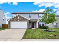 Charming two-story home with brick accents, a two-car garage, and lush front yard landscaping at 7865 Danube St, Indianapolis, IN 46239