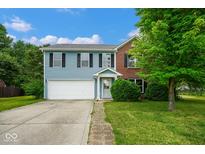 Charming two-story home with blue siding, brick accents, and attached two-car garage at 8047 Red Barn Cir, Indianapolis, IN 46239
