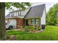 Charming two-story townhouse with brick and siding, a well-manicured lawn, and a one-car garage at 1106 Barbara Dr, Greenwood, IN 46143