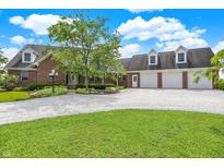 Charming brick home featuring an expansive front yard, dormer windows, three-car garage, and lush landscaping at 11250 N 600 W, Fountaintown, IN 46130