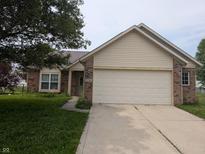 Charming brick and siding home featuring a two-car garage and well-maintained front yard at 11726 Pawleys Ct, Indianapolis, IN 46235