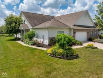 Charming home featuring well-maintained landscaping, lawn, brick accents, and a two-car garage at 1201 Fantail Dr, Greenwood, IN 46143