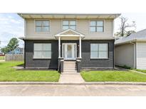Charming two-story home featuring a welcoming front porch and well-maintained lawn at 1302 Main St, Elwood, IN 46036