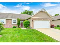 Charming home featuring a two-car garage, brick accents, and a well-maintained lawn at 1331 Mccormicks Cir, Danville, IN 46122