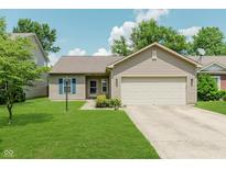 Charming single-story home featuring a two-car garage, well-manicured lawn, and blue shutters at 15388 Dry Creek Rd, Noblesville, IN 46060