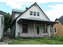 Exterior of a two-story home with a covered porch needing renovation at 1601 Spann Ave, Indianapolis, IN 46203