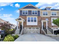Beautiful two-story brick townhouse with a two-car garage and well-maintained landscaping at 16057 Coleman Dr, Westfield, IN 46074