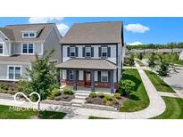 Charming two-story home with front porch, landscaping, and traditional architectural details at 1892 Ponsonby Dr, Westfield, IN 46074
