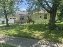 Charming single-story home with a front porch and well-manicured lawn at 1919 Manor Dr, Lebanon, IN 46052