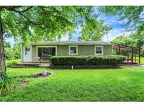 Charming single-story home featuring a welcoming front porch and a well-maintained, lush green lawn at 217 W Burnside Ave, Fairland, IN 46126