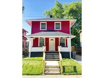 Charming red two-story home with a welcoming front porch and well-maintained lawn at 2423 E 13Th St, Indianapolis, IN 46201