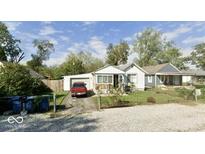 Charming single story home with a driveway and a detached garage in a residential neighborhood at 2638 S Mcclure St, Indianapolis, IN 46241