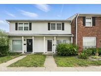 Traditional two-story townhome featuring a classic white facade, black shutters and neatly kept lawn at 3343 Ashley Ln, Indianapolis, IN 46224