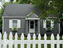 Charming single-story home with grey siding, white trim, and a welcoming front porch at 4405 Primrose Ave, Indianapolis, IN 46205